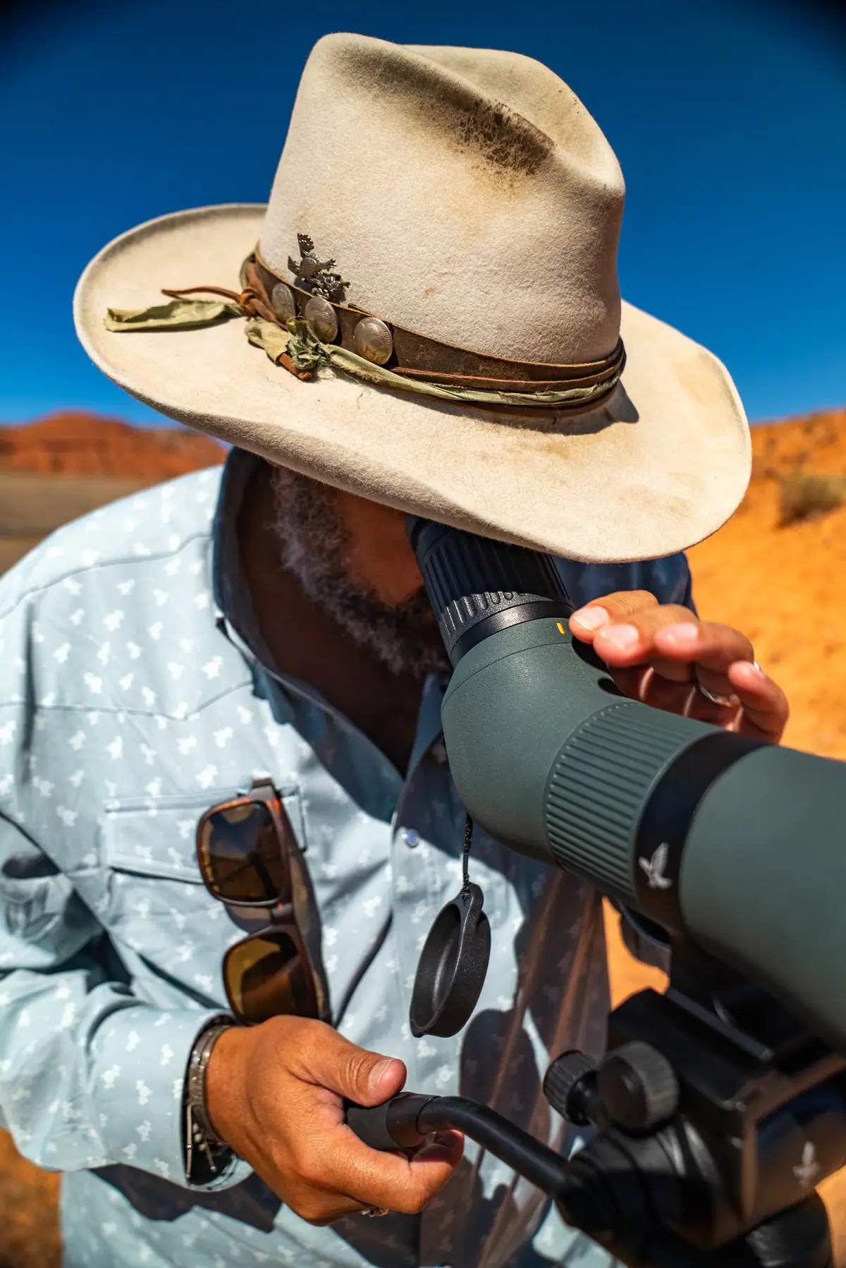 Josh Crumpton glassing through a Swarovski spotting scope at Paintrock Canyon Ranch
