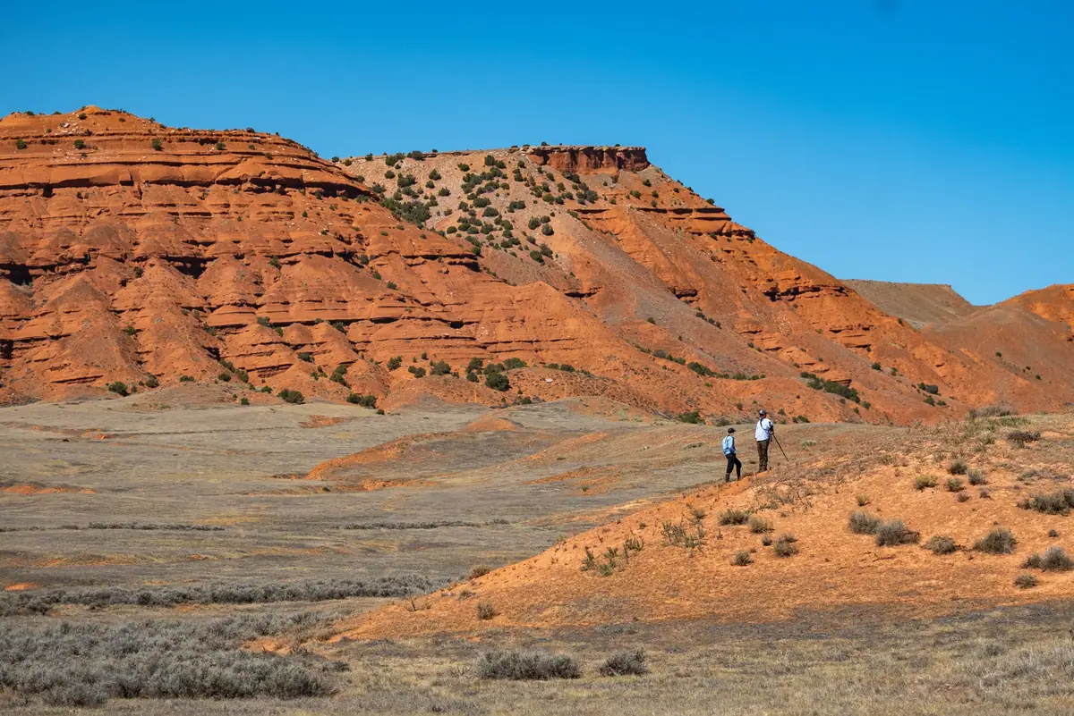 Guests glassing below the red cliffs of Paintrock Canyon Ranch, Wyoming